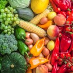 Fruits and vegetables overhead assortment colorful background green, yellow to red