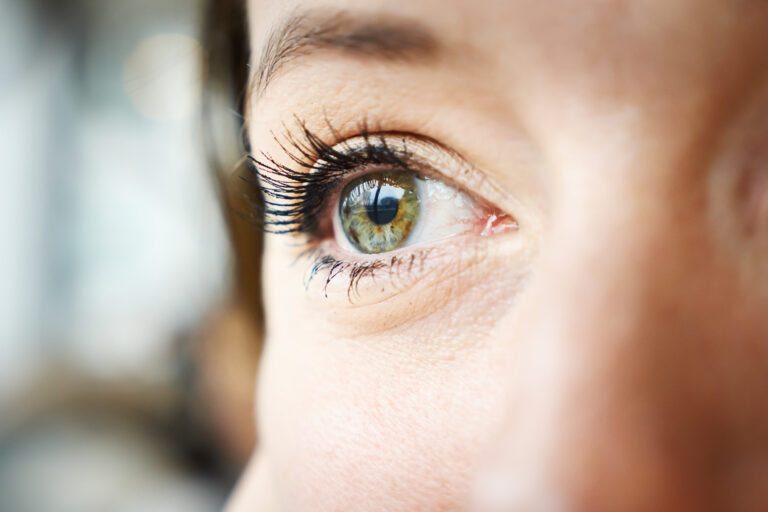 close up to a young woman's bright and green eyes. she is in love and dreams of her new boyfriend